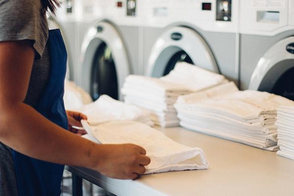 woman folding sheets